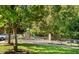 View of the community playground offering a safe space for children to play surrounded by lush green trees at 4555 Sugarbend Way, Raleigh, NC 27606