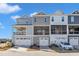 Rear exterior view showing private balconies and garages offering both outdoor living space and convenient parking at 507 Gateway Townes Blvd, Wake Forest, NC 27587