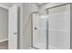 This bathroom has a glass shower with white walls, chrome trim, and a white door leading to another room at 507 Gateway Townes Blvd, Wake Forest, NC 27587