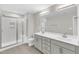 Modern bathroom featuring a glass-enclosed shower, a dual-sink vanity and stylish gray and white finishes at 507 Gateway Townes Blvd, Wake Forest, NC 27587