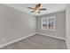 Neutral bedroom with carpet, a ceiling fan, and a window providing natural light at 507 Gateway Townes Blvd, Wake Forest, NC 27587