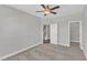 Neutral bedroom with carpet, ceiling fan, closet, and a doorway to stairs at 507 Gateway Townes Blvd, Wake Forest, NC 27587