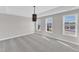 A bright bedroom with three windows, recessed lights, and light gray walls and carpets at 507 Gateway Townes Blvd, Wake Forest, NC 27587