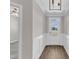 Bright entryway with white wainscoting, wood-look flooring, and modern light fixture at 507 Gateway Townes Blvd, Wake Forest, NC 27587