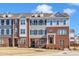 Charming townhome exterior boasting brick facade, dormers and manicured lawn at 507 Gateway Townes Blvd, Wake Forest, NC 27587