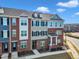Beautiful townhome showcasing brick and siding architecture, complemented by black shutters and a well-maintained lawn at 507 Gateway Townes Blvd, Wake Forest, NC 27587