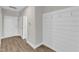 Hallway featuring wood-look flooring and a white shiplap wall with coat hooks at 507 Gateway Townes Blvd, Wake Forest, NC 27587