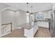 Bright kitchen features an island, pendant lights, and stainless steel appliances at 507 Gateway Townes Blvd, Wake Forest, NC 27587