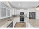 Modern kitchen featuring granite countertops, stainless appliances, and ample storage at 507 Gateway Townes Blvd, Wake Forest, NC 27587