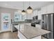 Stylish kitchen with granite countertops, stainless steel appliances, and island with pendant lights at 507 Gateway Townes Blvd, Wake Forest, NC 27587