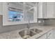 Modern kitchen sink with a view, granite countertops and gray subway tile backsplash at 507 Gateway Townes Blvd, Wake Forest, NC 27587