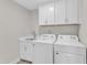 Well-equipped laundry room with modern washer, dryer, sink, and storage cabinets at 507 Gateway Townes Blvd, Wake Forest, NC 27587
