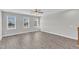 Bright living room with wood floors, ceiling fan, and multiple windows for natural light at 507 Gateway Townes Blvd, Wake Forest, NC 27587