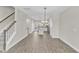 Open-concept living space featuring wood floors, modern lighting, and staircase to the second floor at 507 Gateway Townes Blvd, Wake Forest, NC 27587