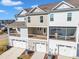 Townhome rear view featuring garages, decks, and screened porches, creating appealing outdoor living spaces at 507 Gateway Townes Blvd, Wake Forest, NC 27587