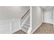 Carpeted staircase with white risers and wood handrail and landing at the top at 507 Gateway Townes Blvd, Wake Forest, NC 27587
