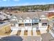 A nice view of townhomes with attached garages and small lawns, and small balconies on the back at 507 Gateway Townes Blvd, Wake Forest, NC 27587