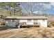 Backyard view of home with wooden deck at 5848 Yates Mill Pond Rd, Raleigh, NC 27606