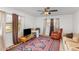 A comfy bedroom featuring neutral paint, large area rug, and a ceiling fan at 5848 Yates Mill Pond Rd, Raleigh, NC 27606