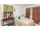 Bedroom with a vanity area, soft lighting, and floral patterned bedding at 5848 Yates Mill Pond Rd, Raleigh, NC 27606