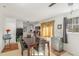 Open dining area with a dark wood table and view into kitchen at 5848 Yates Mill Pond Rd, Raleigh, NC 27606