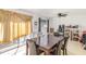 Open dining area with a dark wood table, ceiling fan, and access to the patio at 5848 Yates Mill Pond Rd, Raleigh, NC 27606