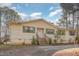 Charming single-story home featuring wood siding, green shutters, and a front porch with wooden steps at 5848 Yates Mill Pond Rd, Raleigh, NC 27606