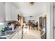 Open kitchen with white cabinets and appliances looking into the dining area at 5848 Yates Mill Pond Rd, Raleigh, NC 27606