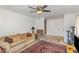 Inviting living room featuring neutral paint, a ceiling fan, and a patterned area rug at 5848 Yates Mill Pond Rd, Raleigh, NC 27606