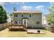 Exterior view of the house with a back deck, patio, and a spacious backyard at 5915 Eaglesfield Dr, Raleigh, NC 27613