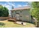 Exterior shot of the house with a back deck, brick patio, and well-maintained backyard at 5915 Eaglesfield Dr, Raleigh, NC 27613