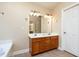 Bathroom featuring a double sink vanity with a wood cabinet and ample lighting at 5915 Eaglesfield Dr, Raleigh, NC 27613