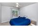 Cozy bedroom featuring a plush blue comforter and natural light from the window at 5915 Eaglesfield Dr, Raleigh, NC 27613