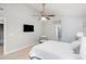 Bright bedroom featuring a chair, TV, and ample space, complemented by a ceiling fan at 5915 Eaglesfield Dr, Raleigh, NC 27613