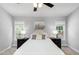 Serene bedroom with a plush bed, side tables, and large windows offering natural light at 5915 Eaglesfield Dr, Raleigh, NC 27613