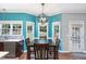 Eat-in kitchen features an adjacent dining area with bay windows, wooden table set, and natural light at 5915 Eaglesfield Dr, Raleigh, NC 27613
