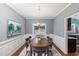 Traditional dining room with wainscoting and a wooden table under an elegant chandelier at 5915 Eaglesfield Dr, Raleigh, NC 27613