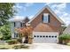 Charming two-story brick and siding home featuring a two-car garage and manicured landscaping at 5915 Eaglesfield Dr, Raleigh, NC 27613