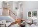Inviting living room featuring a soaring ceiling, hardwood floors, and a staircase at 5915 Eaglesfield Dr, Raleigh, NC 27613