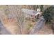 Aerial shot of a brick home with a long driveway and mature trees at 6404 Dixon Dr, Raleigh, NC 27609