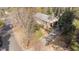 Aerial view of brick home with mature landscaping, long driveway, and brick accents at 6404 Dixon Dr, Raleigh, NC 27609