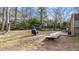 Spacious backyard with covered grill, wooden walkway, and seating area at 6404 Dixon Dr, Raleigh, NC 27609