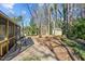 Backyard featuring a screened porch, patio, sheds, fire pit, and mature trees at 6404 Dixon Dr, Raleigh, NC 27609
