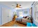 Light-filled bedroom featuring hardwood floors, two windows and a ceiling fan at 6404 Dixon Dr, Raleigh, NC 27609