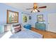 Bright bedroom with hardwood floors, ceiling fan, and vintage-style furniture at 6404 Dixon Dr, Raleigh, NC 27609