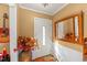 Inviting home entryway with natural lighting, decorative vase, and unique mirror at 6404 Dixon Dr, Raleigh, NC 27609