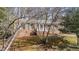 Home's front exterior featuring traditional brickwork, trimmed front yard, and mature trees in the landscaping at 6404 Dixon Dr, Raleigh, NC 27609