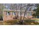 Charming brick home featuring green shutters and a welcoming front porch at 6404 Dixon Dr, Raleigh, NC 27609