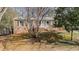 Home's front exterior featuring traditional brickwork, trimmed front yard, and mature trees in the landscaping at 6404 Dixon Dr, Raleigh, NC 27609