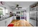 Well-lit kitchen with white cabinets, stainless steel appliances, and black countertops offers functionality and style at 6404 Dixon Dr, Raleigh, NC 27609